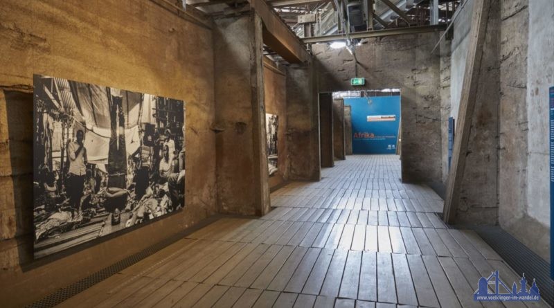 Blick in die Ausstellung "Afrika – Im Blick der Fotografen" des Weltkulturerbes Völklinger Hütte, im Vordergrund ein Werk von Kibuuka Mukisa Oscar aus der Serie "Breaking Uganda" Copyright Foto: Weltkulturerbe Völklinger Hütte/Hans-Georg Merkel